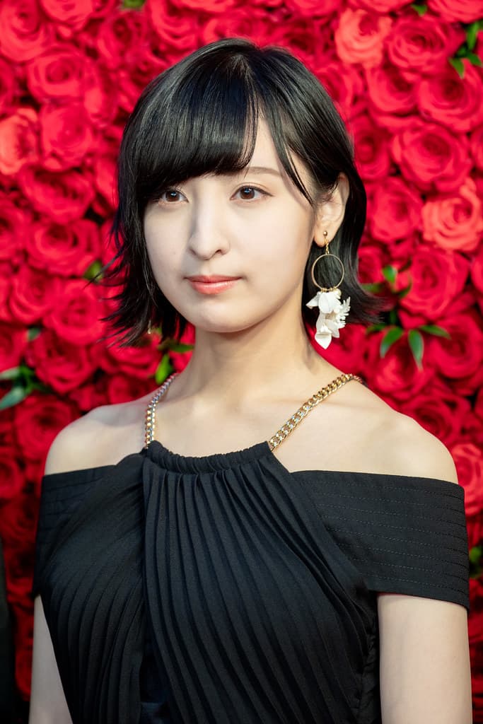 Ayane Sakura, with purple hair and a determined expression, in character as the Star Maiden from Within the Villainess.