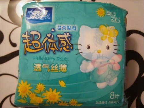 Cover A of Hello Kitty And Friends Hello World #1 by Paulina Ganucheau, featuring Hello Kitty, polybagged with a sticker sheet visible.