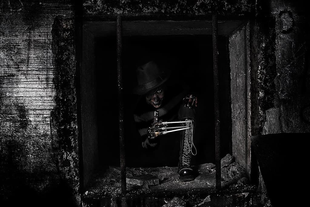 Key art for A Nightmare on Elm Street featuring Freddy Krueger in a dark, stylized setting
