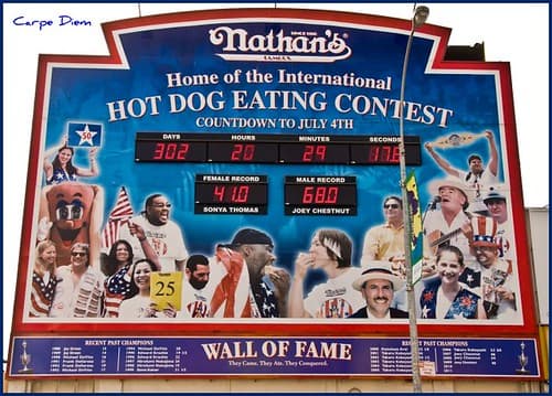 Competitive eaters Miki Sudo and Patrick Bertoletti pose on stage at the Nathan's Famous Hot Dog Eating Contest weigh-in.