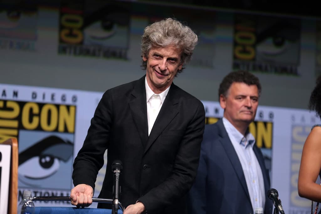 Steven Moffat animatedly telling a story on a television show set